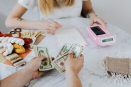 People budgeting with calculator and notebook