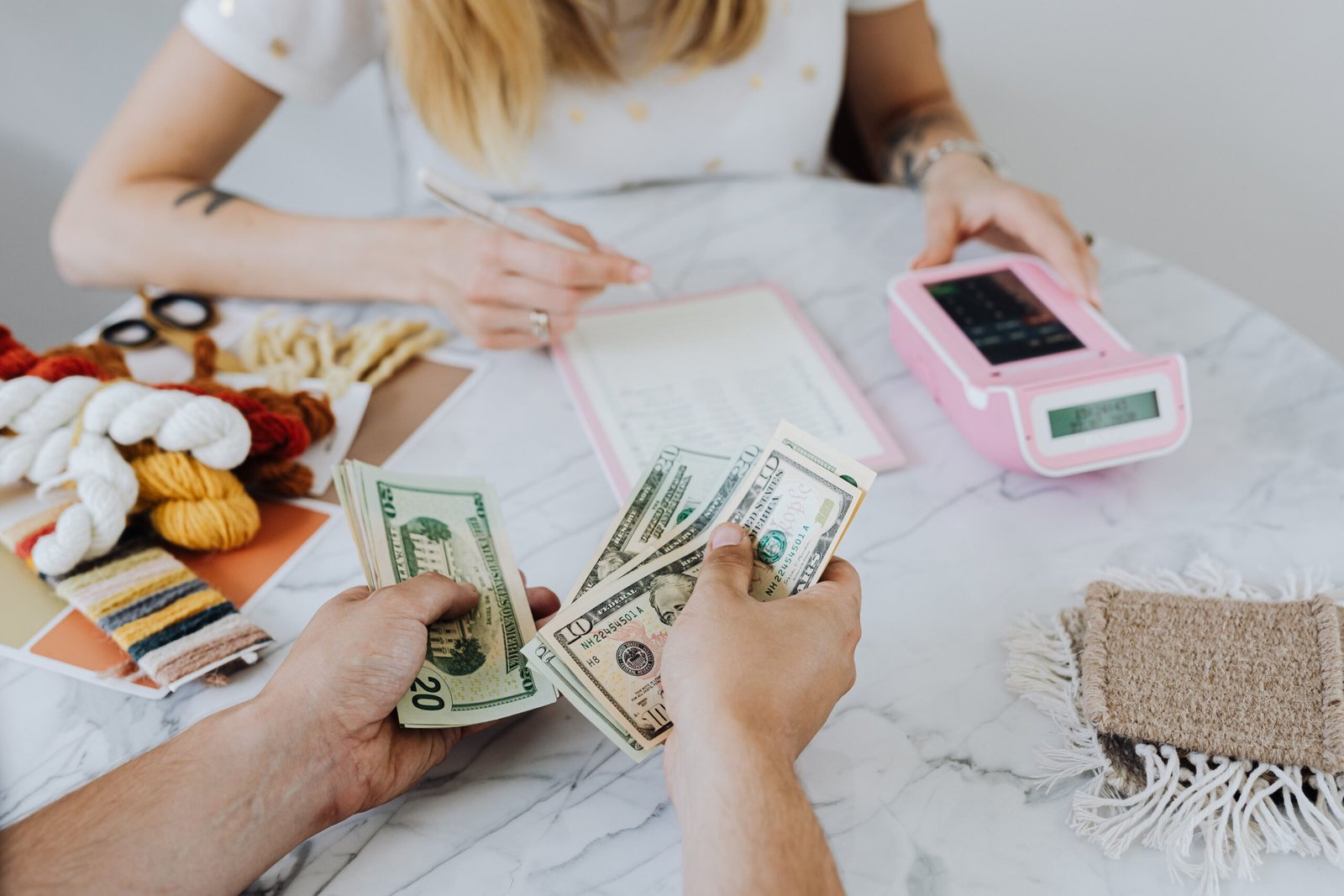 People budgeting with calculator and notebook